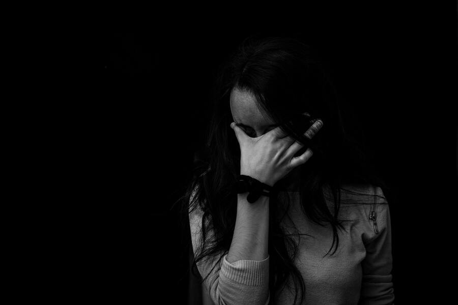 Foto em preto e branco com mulher com sintomas de depressão